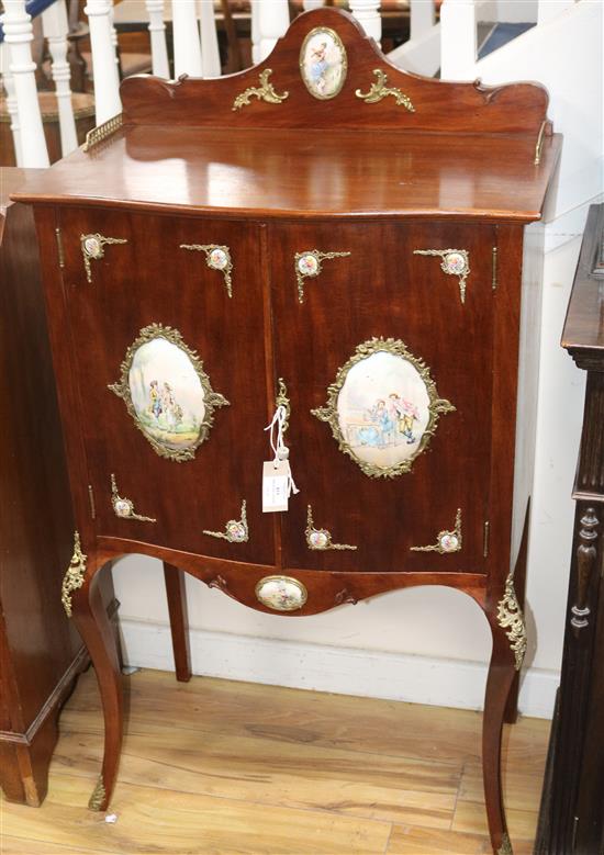 A mahogany cabinet with porcelain panels and brass filigree W.68cm